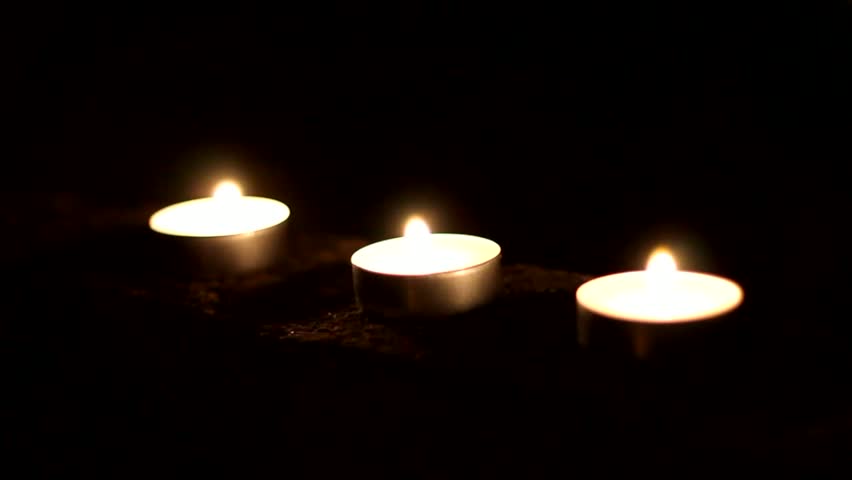 Five Flickering Candles On The Black Background. Stock Footage Video