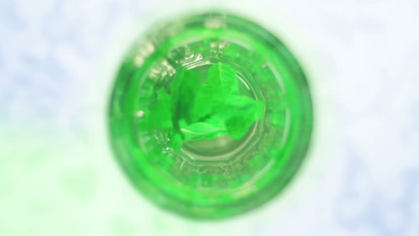 Full HD clip of glass of fresh mint tea with green mint leaves floating in hot water cup. Unique with shallow depth of field.
