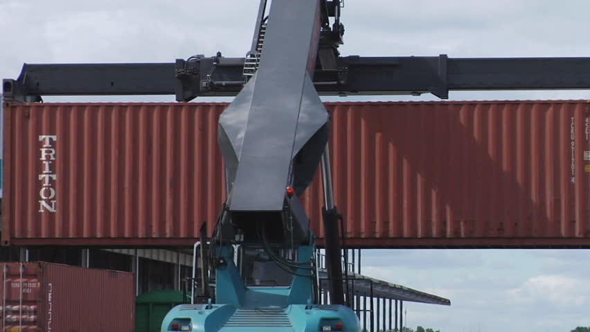 NOVOSIBIRSK, RUSSIA - MAY 20: The Crane puts the container on a train platform in a huge warehouse of containers on May 20, 2010 in Novosibirsk, Russia.