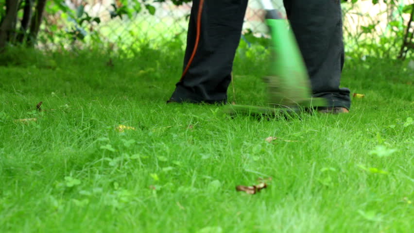 mowing grass with electric grass cutter
