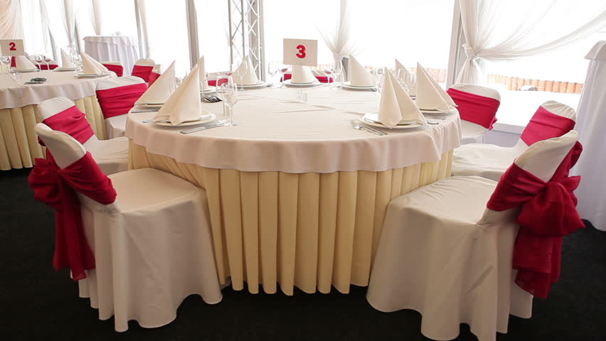 Decorated chairs and set tables in the restaurant ready to receive guests