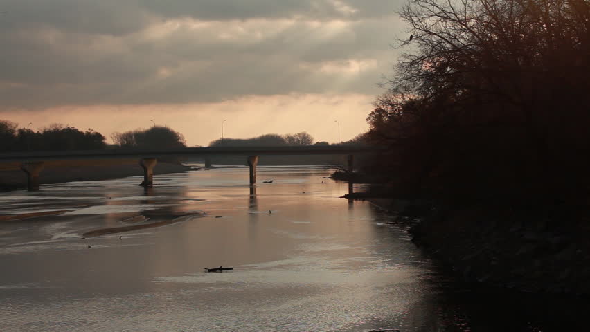 A stationary of a river in the sunset