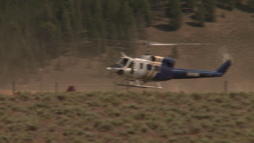 YELLOWSTONE NATIONAL PARK, WYOMING, USA - CIRCA 2011; Landing Helicopter Spews up Dust