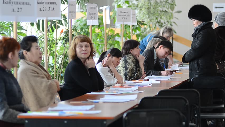 ULAN-UDE, RUSSIA - MARCH 4: The divisional election committee 699 of Burytia Republic register voters at the presidential election of Russian Federation on March 4, 2012 at a local polling station in Ulan-Ude, Buryatia, Russia.