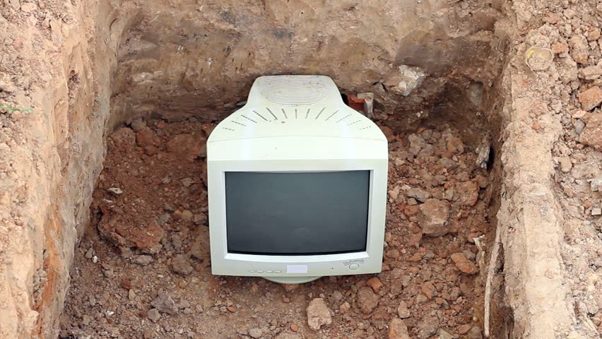 hd video of old computer monitor buried in a grave hole