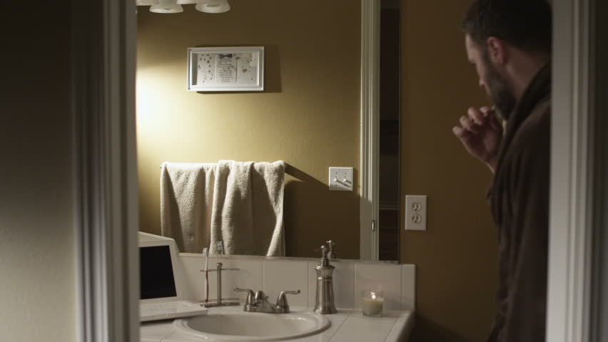 A couple  balancing home life and professional life. Authentic moments around the house are captured as the couple gets ready for the day, completes work on the computer.