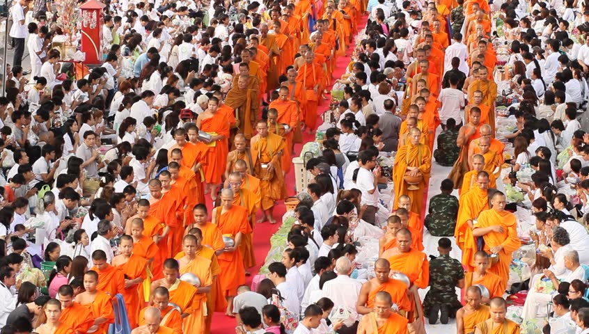 BANGKOK , THAILAND - MARCH 17: People give food offerings to Buddhist monks on March 17, 2012 in Bangkok, Thailand.