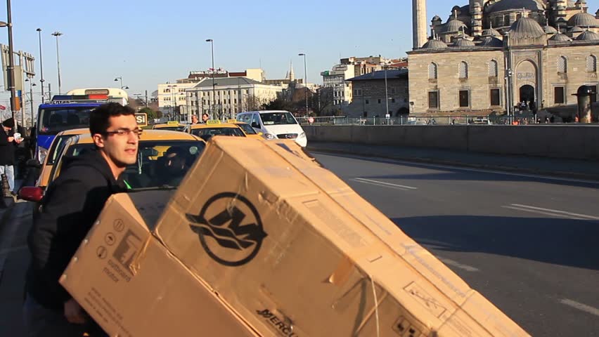 ISTANBUL - MARCH 6: An unidentified porter carries cardboard boxes at Eminonu on March 6, 2012 in Istanbul. Eminonu region is a bustling maze of seemingly workaday streets. 
