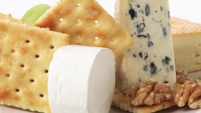 Cheese plate with crackers, grapes and walnuts