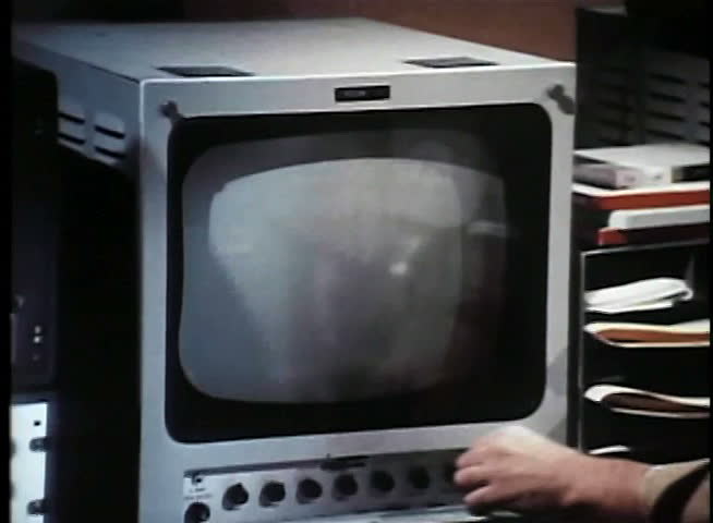 Medium shot of man turning on surveillance monitor