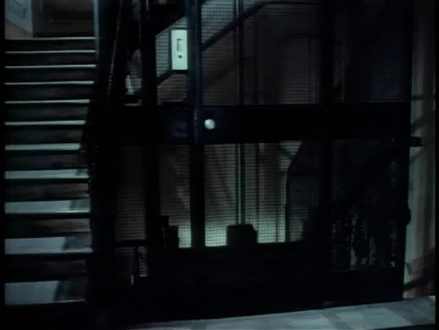 Wide shot of cage elevator going up