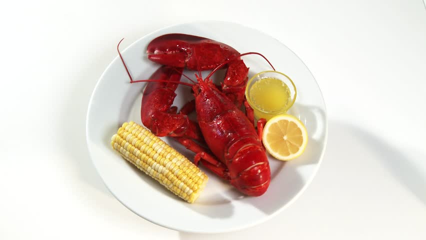Cooked lobster with corn on the cob and butter sauce