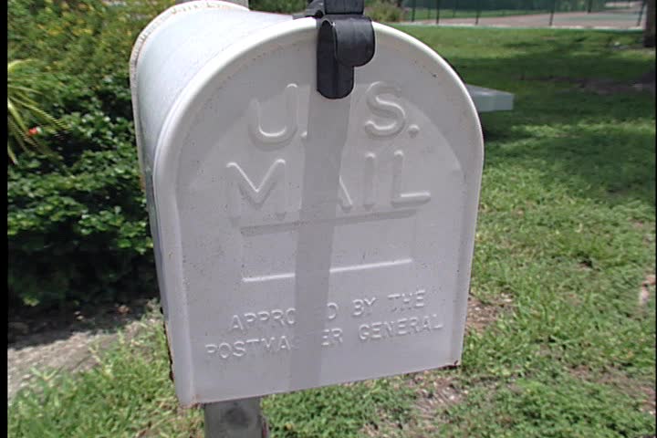 Putting letters in the mailbox. 