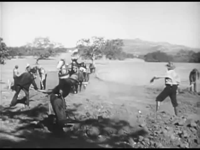 Farmers working the land with plough horses