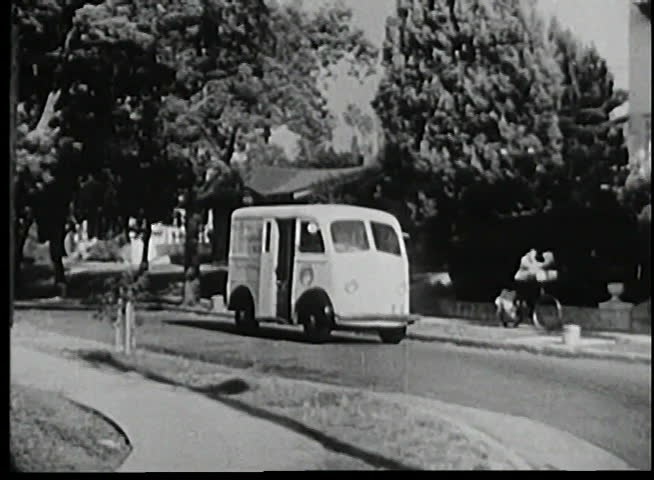 Milk truck driving along street