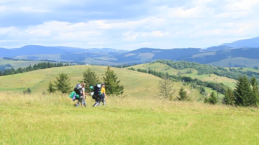 Hikers walking through ameadow