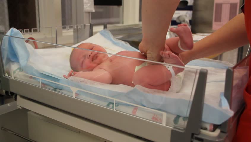 A newborn baby at the hospital born just minutes before being cleaned by the nursing staff.