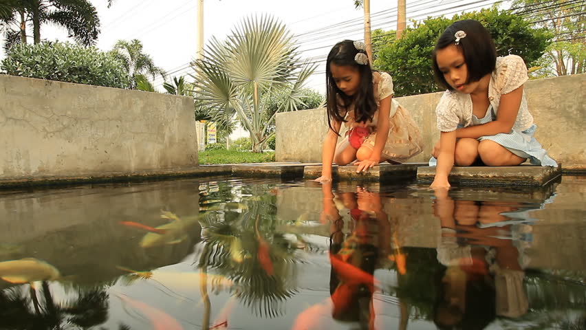 Asian girls with a fish pond.