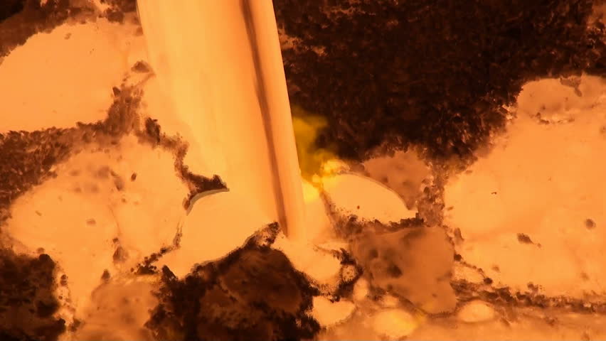 Macro view of liquid metal from blast furnace at the metallurgical plant. Temperature of this liquid metal is 1600 Celsius degrees