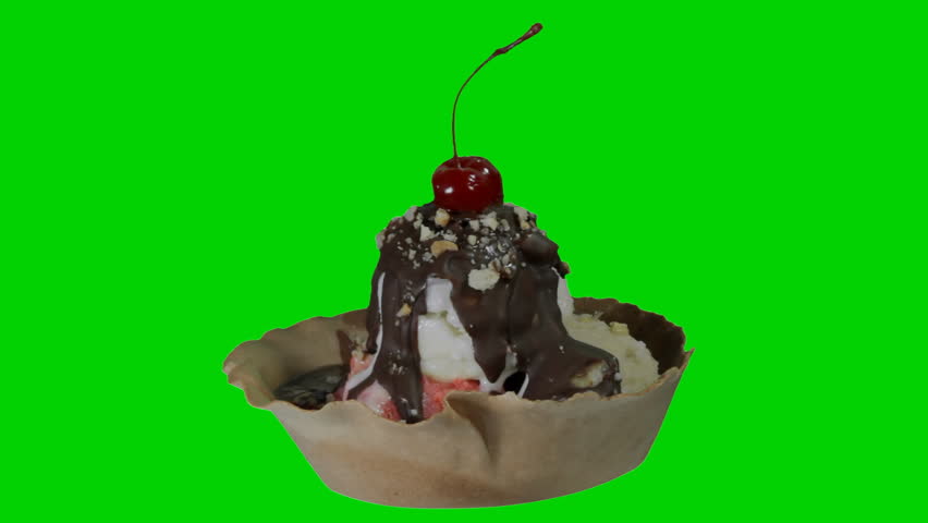 Ice Cream Sundae Rotating (HD). Chocolate drenched three flavor ice cream sundae. Use the green screen to get rid of the color and place your background to use as a screen or design element.