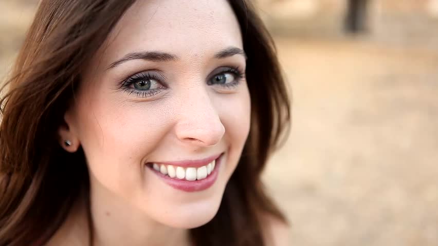 Young cheerful woman with dreamy look