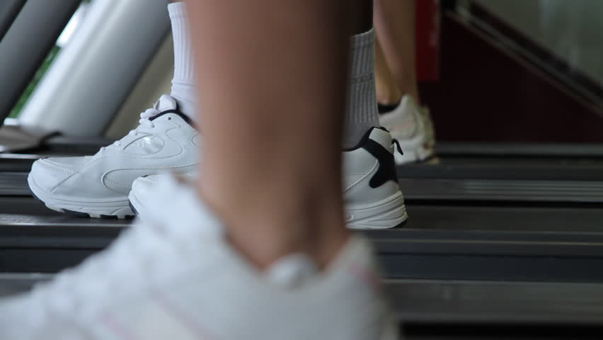 Feet running treadmills cardio workout exercise in gym