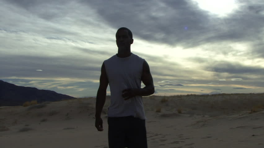 Male drinking water in desert