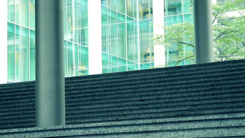 Business man leaving office and answering phone call