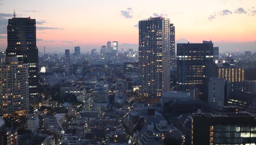 Aerial view of high-rise office buildings and residential area in downtown Tokyo, Japan during sunset