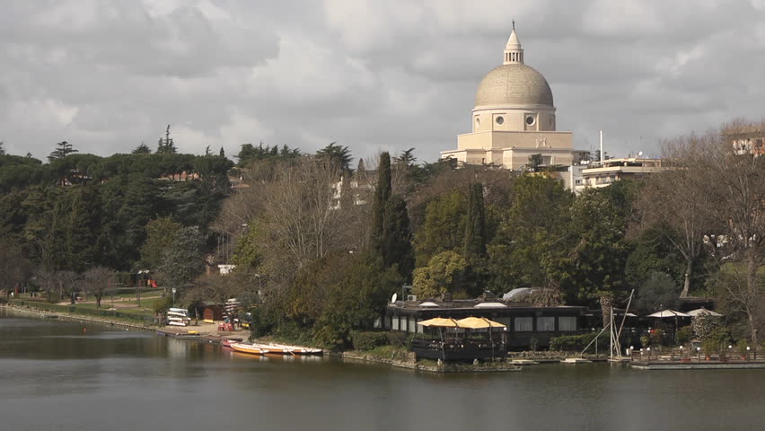 Urban view of Rome, Italy, city with old buildings, monuments and art: Basilica Santi Pietro e Paolo, catholic church near lake, EUR district
