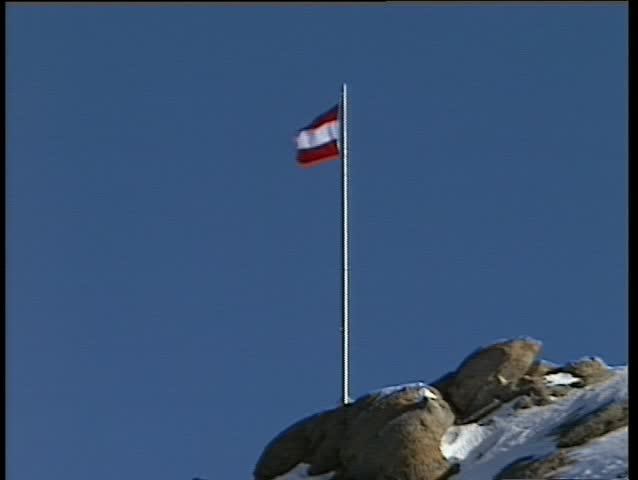 The Austrian flag on top of a mountain