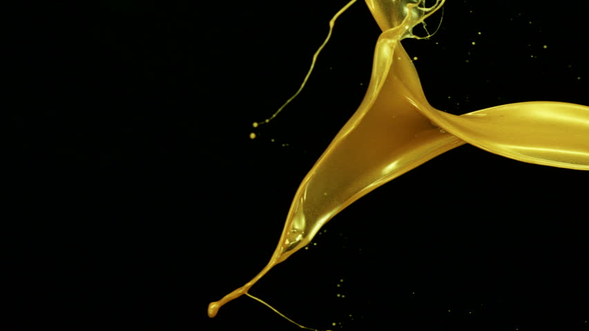 Gold liquid splash in the air on black background shooting with high speed camera, phantom flex.