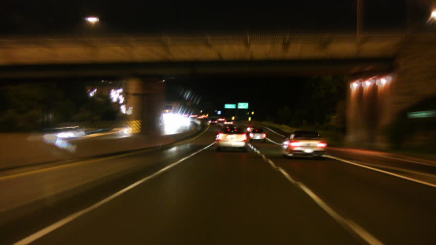Timelapse shot. Driving at night on a wet, Toronto highway. 