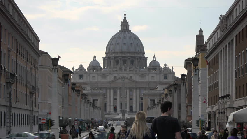 People in Vatican City near Saint Peter's basilica, famous cathedral in Rome. Zoom out