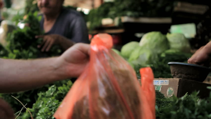 Buying vegetables at the marketplace in Tel-Aviv