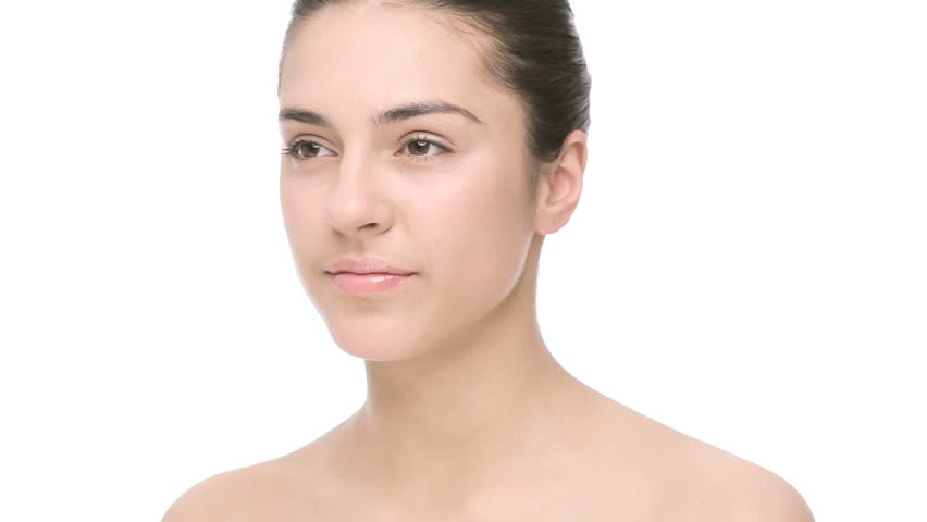 female touching her face turning and looking at camera