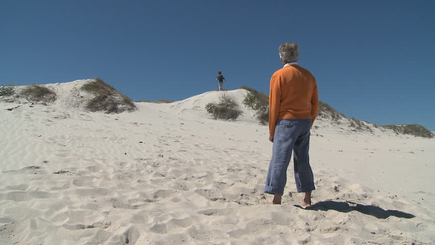 LONG SHOT OF A GRANDSON RUNNING TO HIS GRANDFATHER