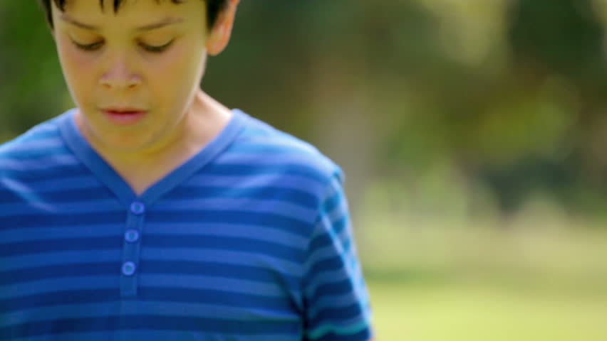 Smiling boy playing with a soccer ball in the countryside