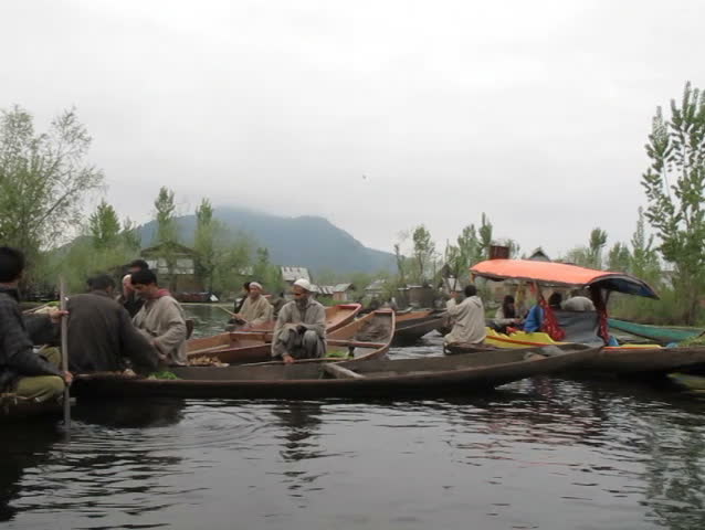 SRINAGAR - APRIL 14: Tourist riding Shikara to visit Daily floating vegetable market on Dal lake on April 11, 2012 in Srinagar, India. 