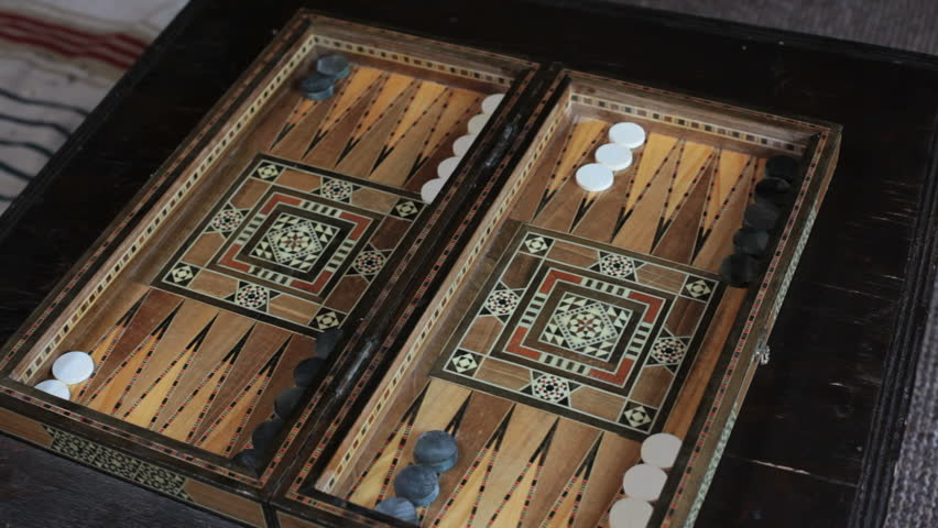 girl playing backgammon, throws dice and moves pieces