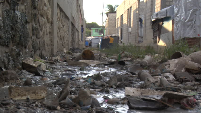 PORT-AU-PRINCE - CIRCA OCTOBER 2010: Trash and stagnant water in a tent city in St. Martin in Port-au-Prince, Haiti circa October 2010.