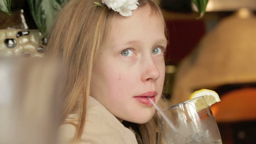 Young girl drinking lemonade