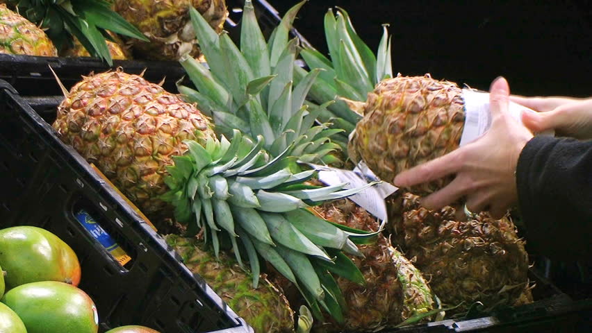 Woman Selects Pineapple 