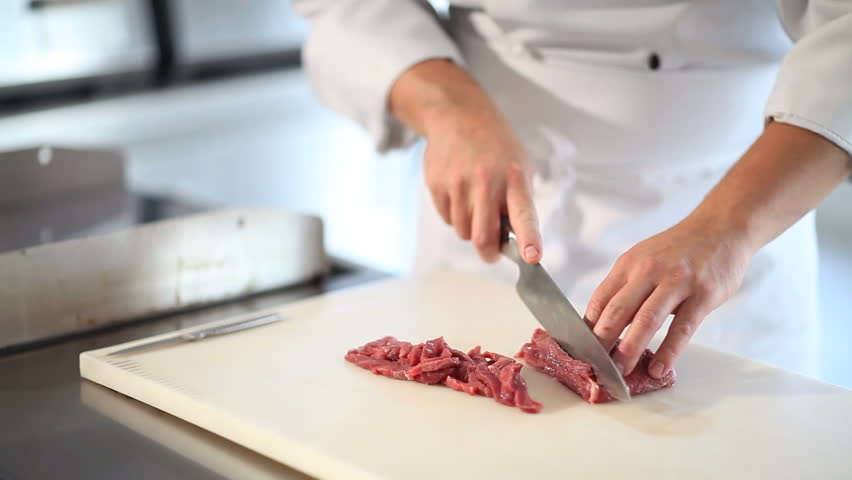 hands cutting fresh meat
