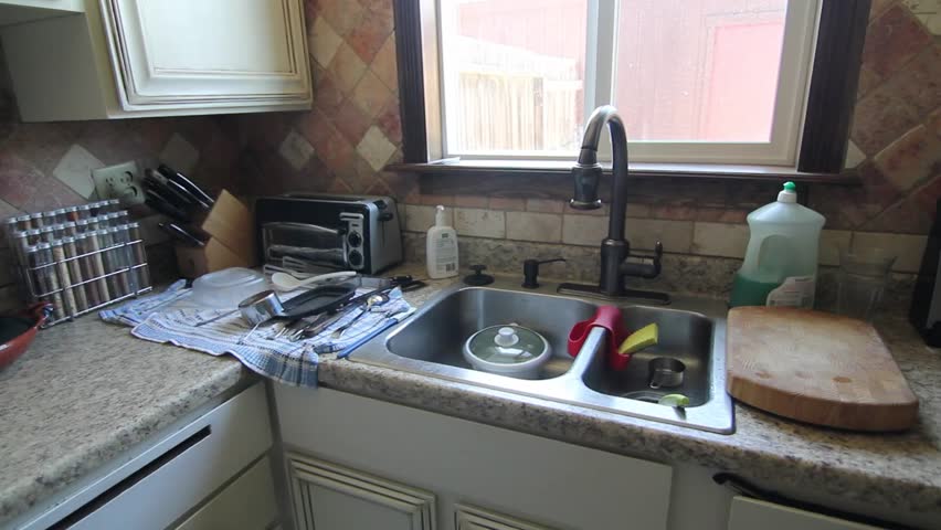 Time lapse of man cleaning his kitchen