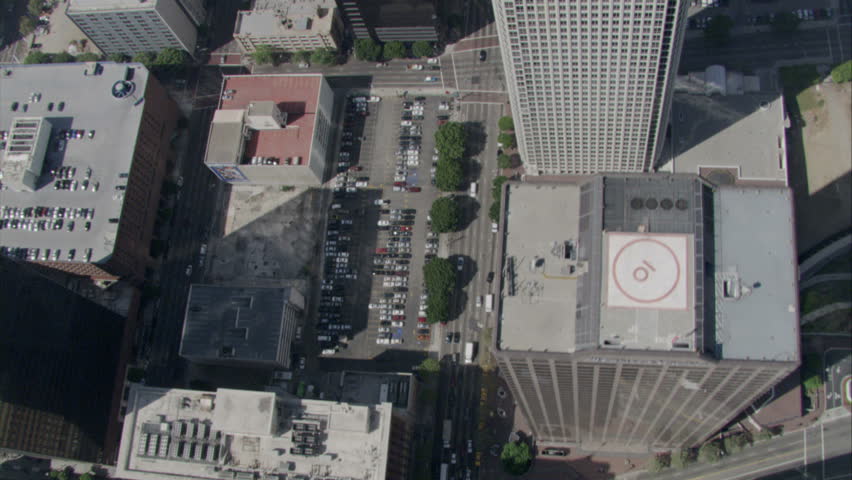 aerial pass over Los Angeles downtown urban streets over the tops of buildings circa 2009