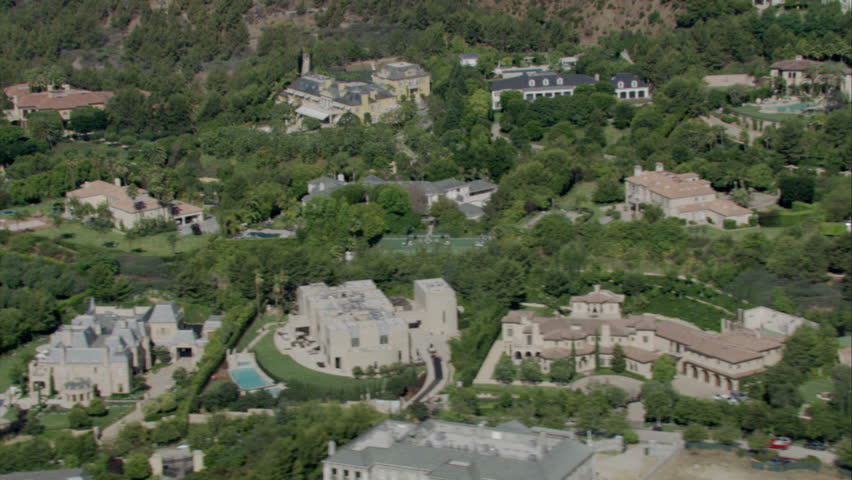 aerial flying shot of many luxurious homes in an upscale area circa 2009