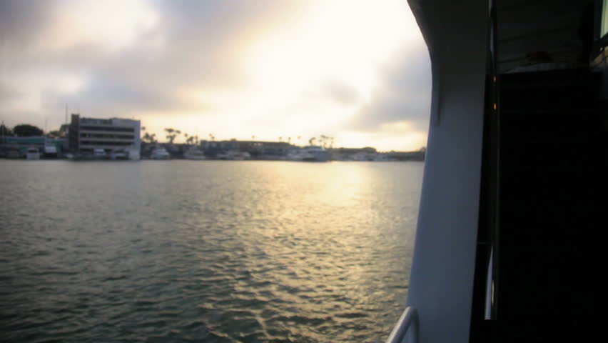 Ocean harbor with setting sun glistening off the water