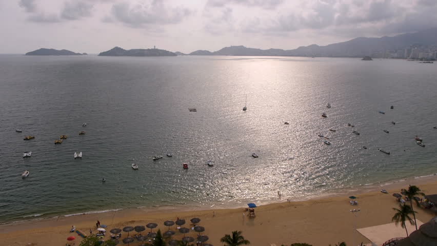 Acapulco Beach Lapse (HD). Time lapse showing boats, waves and unrecognizable people at an Acapulco Mexico beach.