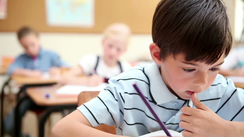 Thoughtful pupil working in the classroom